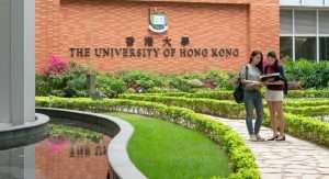 Junket Education Hong Kong three Singapore Two Study Abroad Service, their students stand in front of the University of Hong Kong's academic building, discussing the content of their studies.