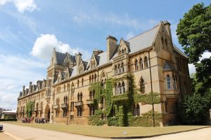 Overseas students stand at the entrance to the university building of a prestigious university with a long history